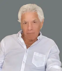 A man with white hair and wearing a shirt.