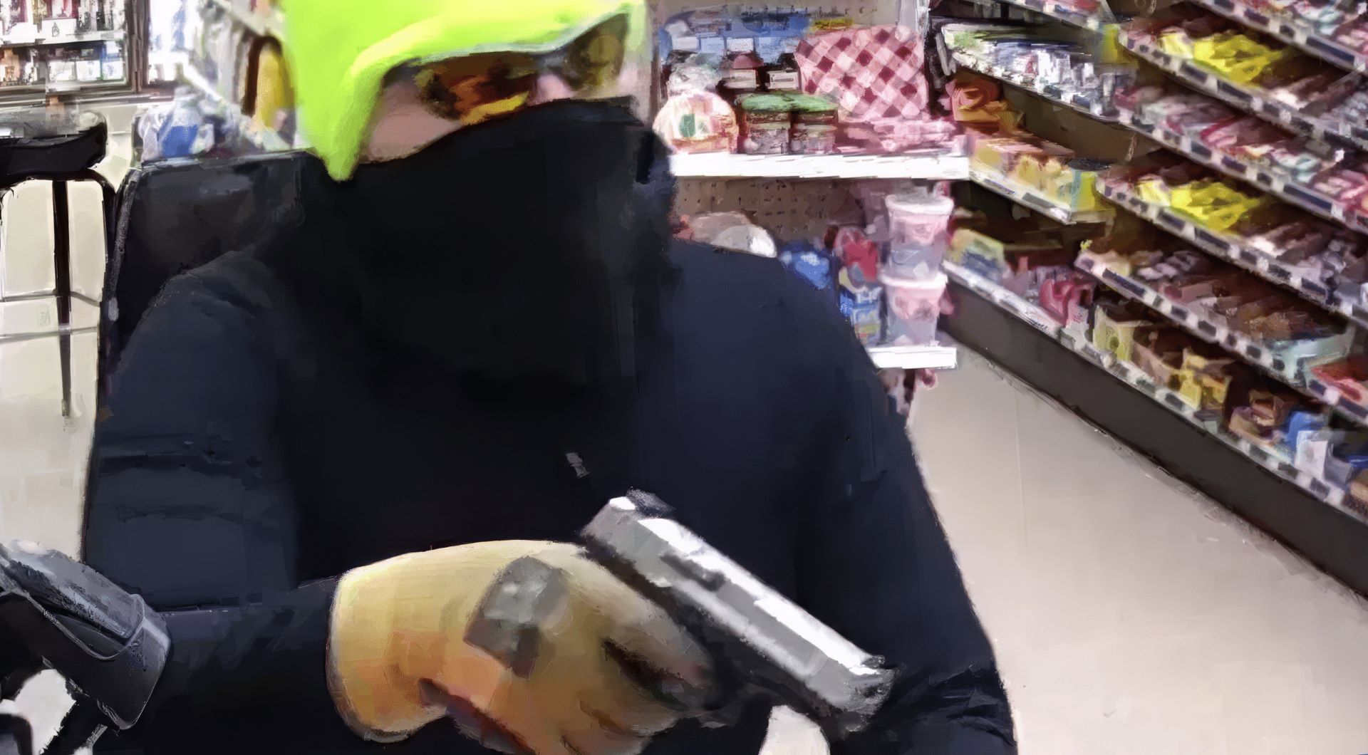 A man in black mask holding a gun.