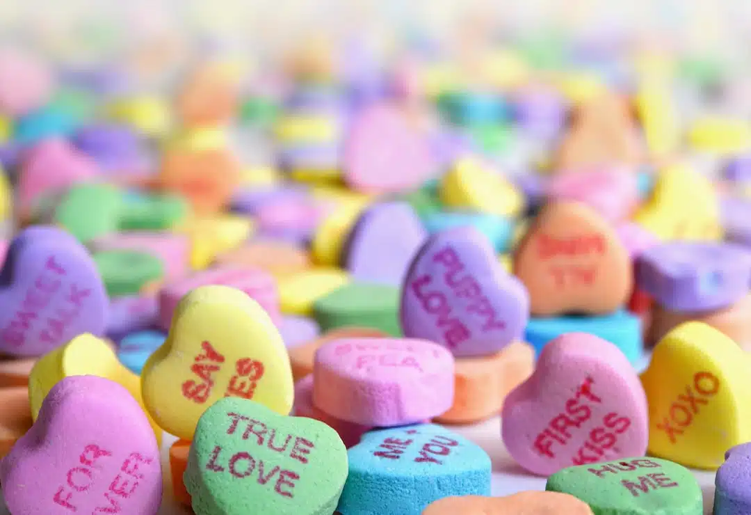 A bunch of candy hearts that are on the ground