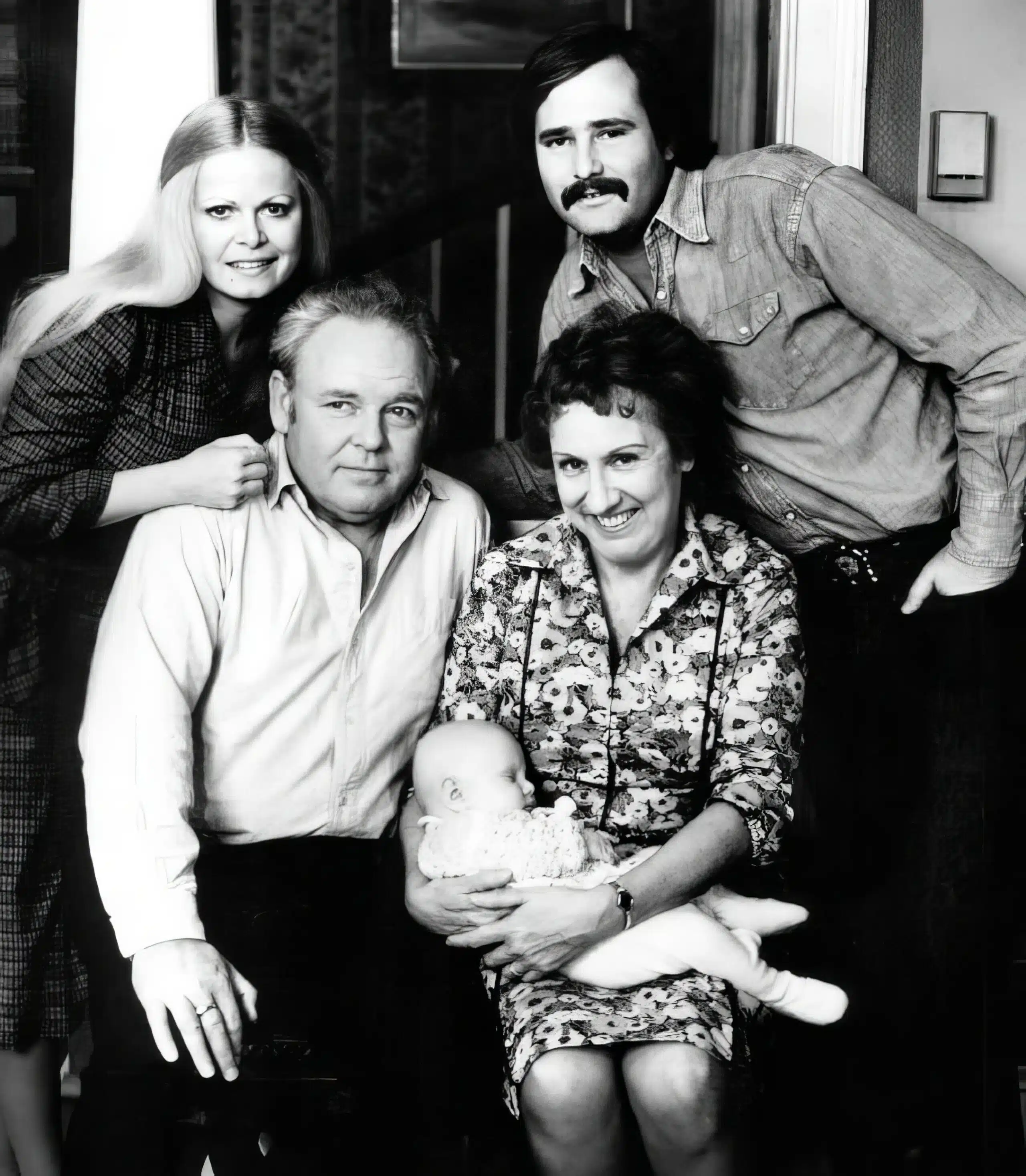 A family posing for the camera in their home.