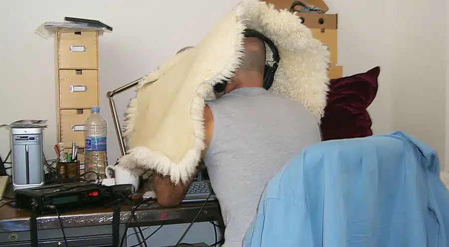 A man holding onto the back of a white blanket